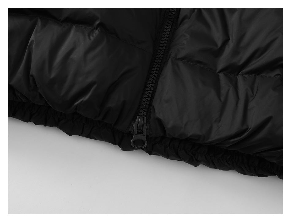 Close-up of the black jacket's front zipper and gathered elastic hem.