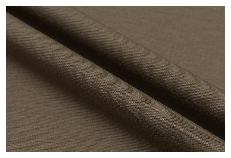 Close-up of taupe fabric draped to show its fine surface texture.