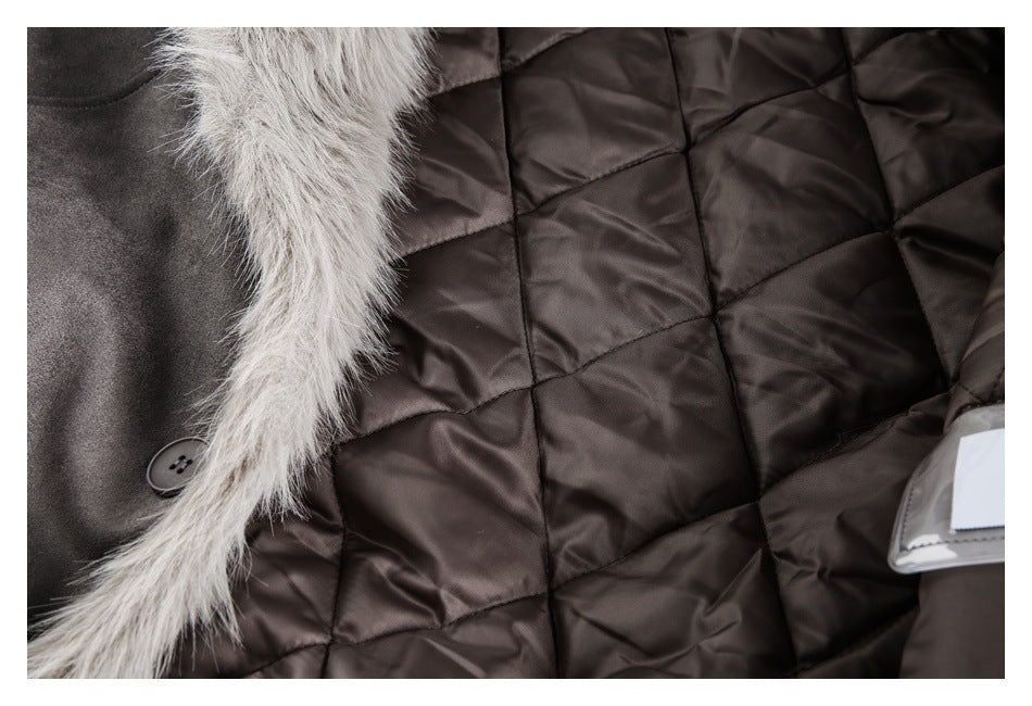 Close-up of a dark quilted coat lining with pale fur trim and a dark button.