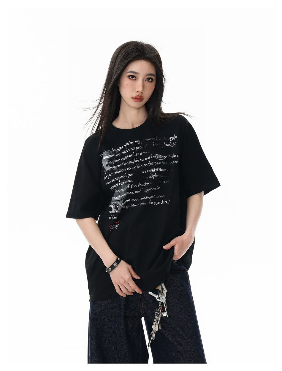 Model wearing a black oversized graphic T-shirt, shown from the front with dark jeans.