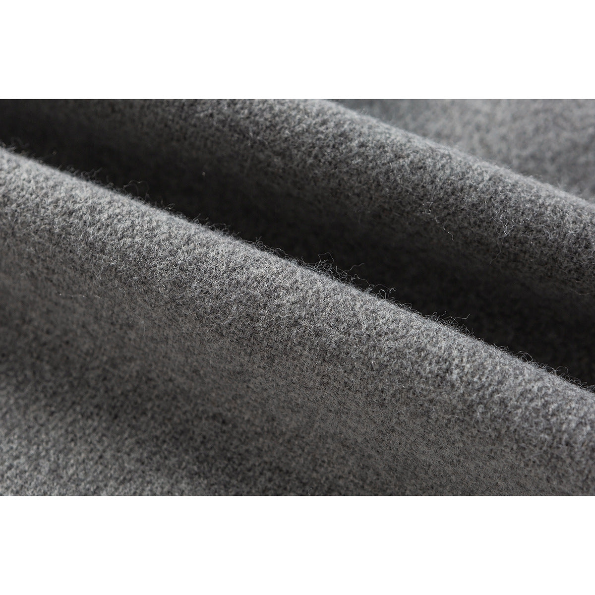 Extreme close-up of the gray jacket fabric showing its soft, fuzzy surface.