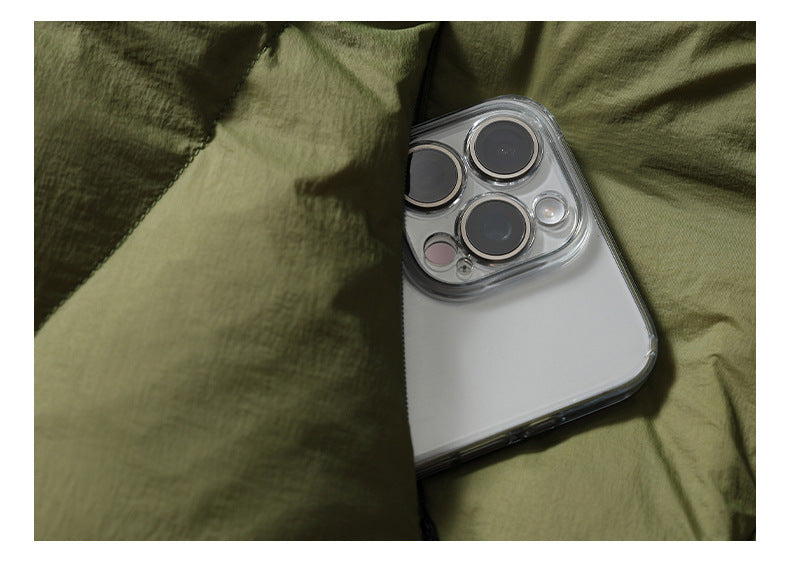 Close-up of olive jacket fabric with a smartphone tucked into a pocket.