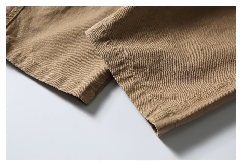 Close-up of the tan bottoms' stitched leg hems.