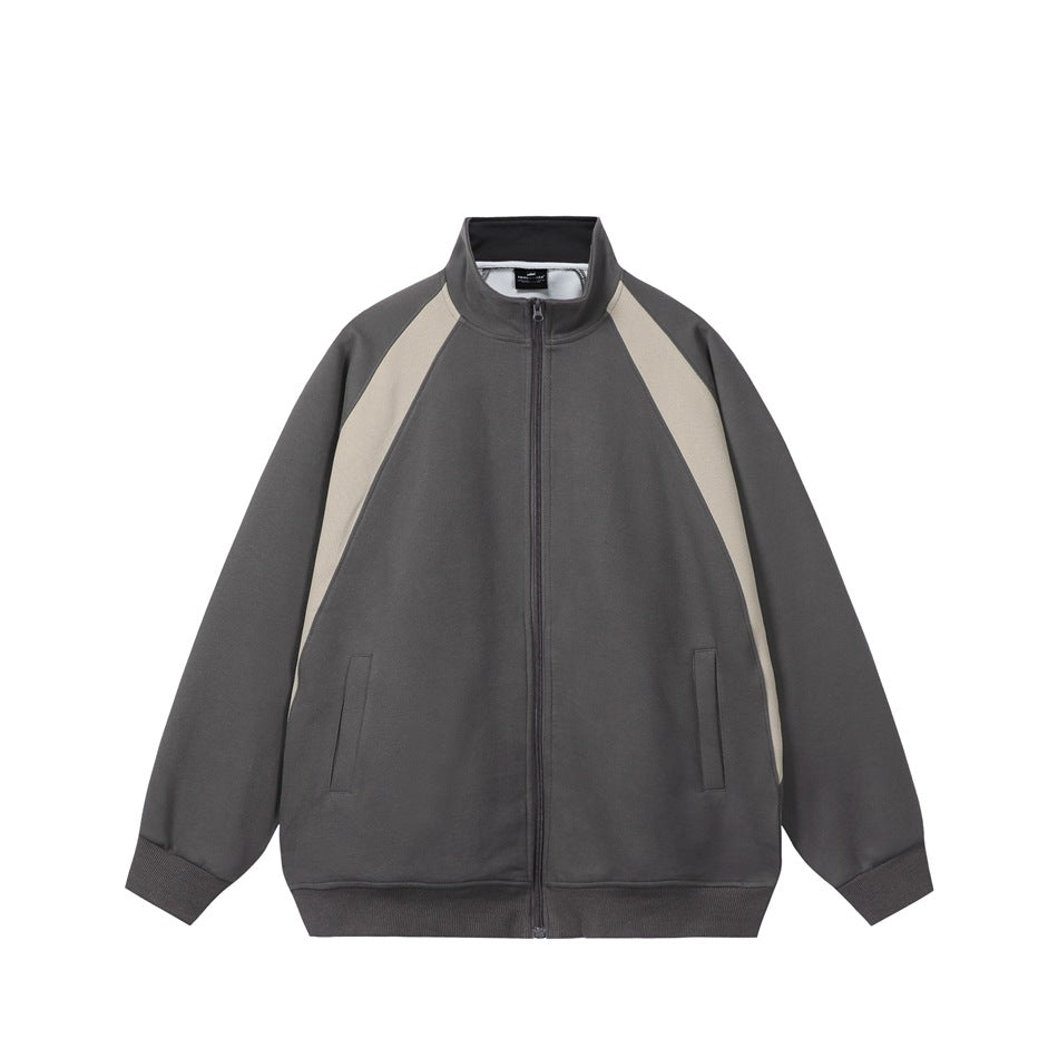 Dark gray zip jacket with light beige raglan panels, stand collar, slit pockets and ribbed cuffs, flat front view