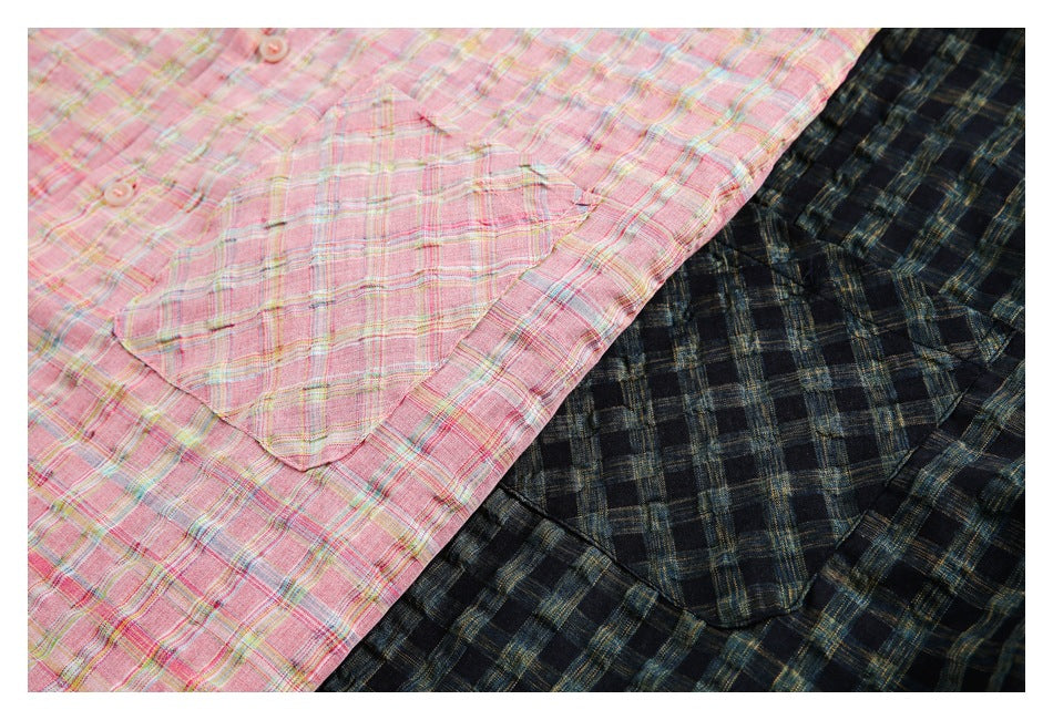 Close-up of pink and dark navy plaid garments showing buttoned fronts and patch pockets.