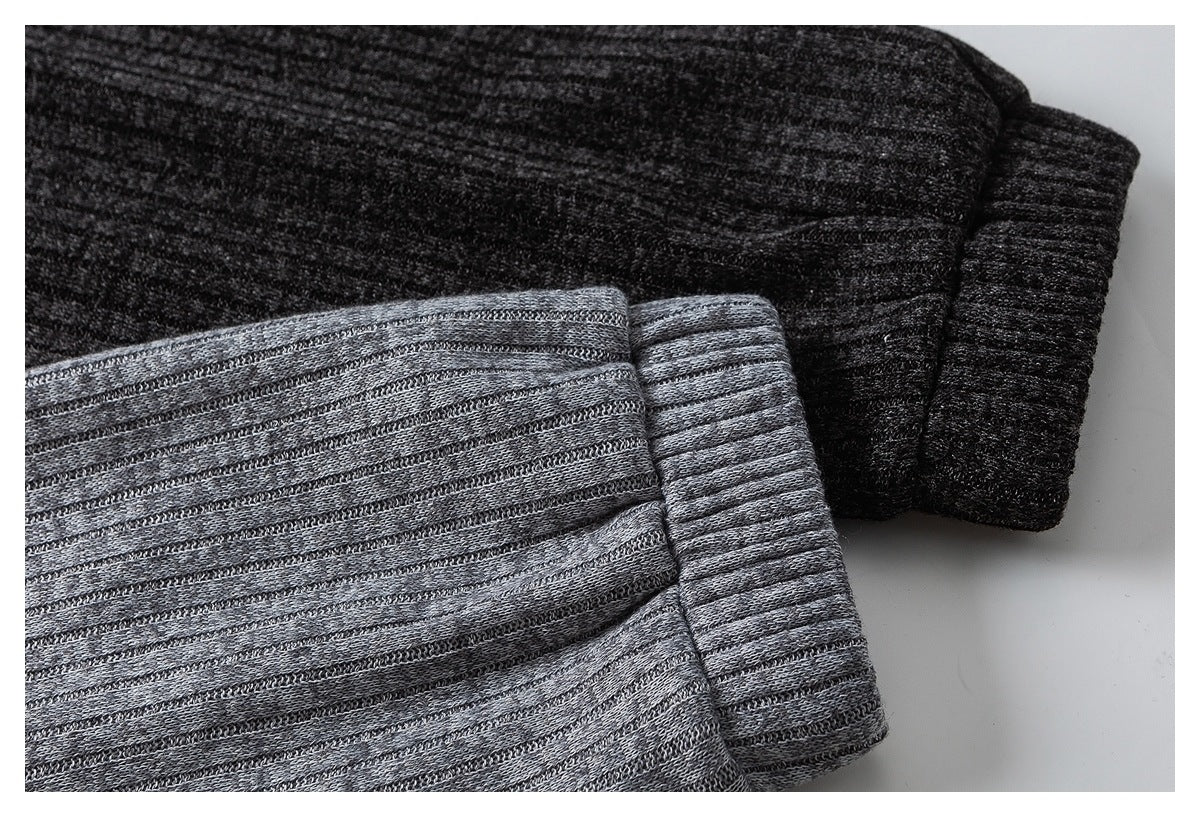 Close-up of dark charcoal and heather gray knit garment cuffs with ribbed edges.