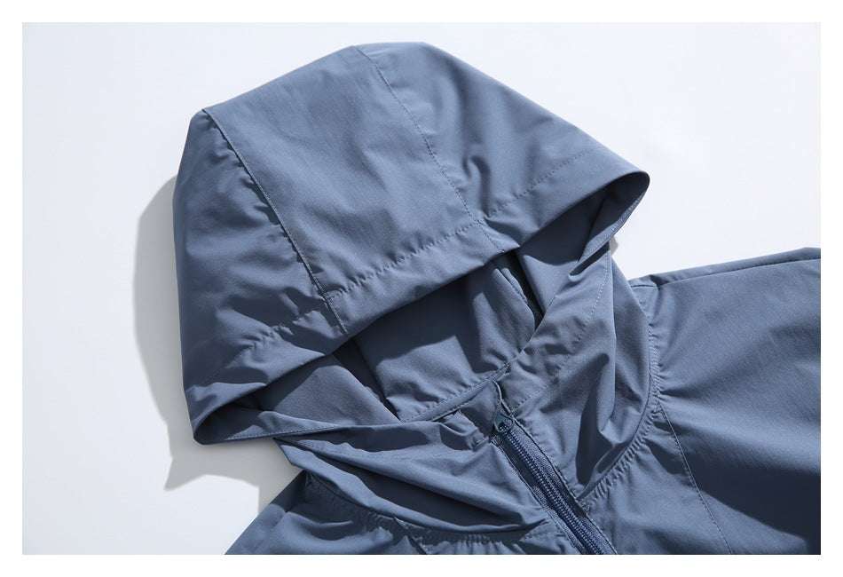 Close-up of a slate-blue jacket hood and front zipper against a white background.