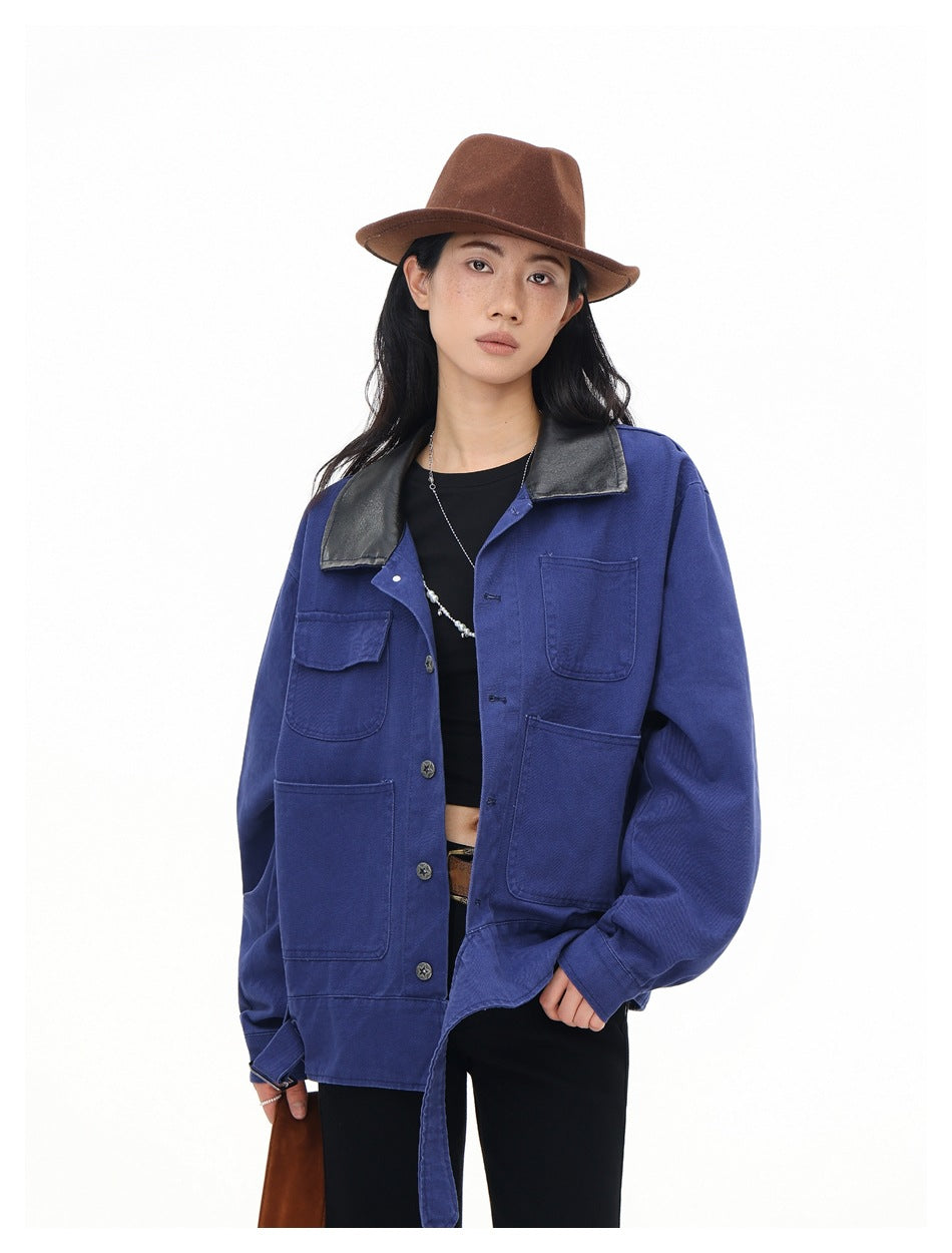 Close view of a model wearing a blue jacket with a black collar and multiple patch pockets.