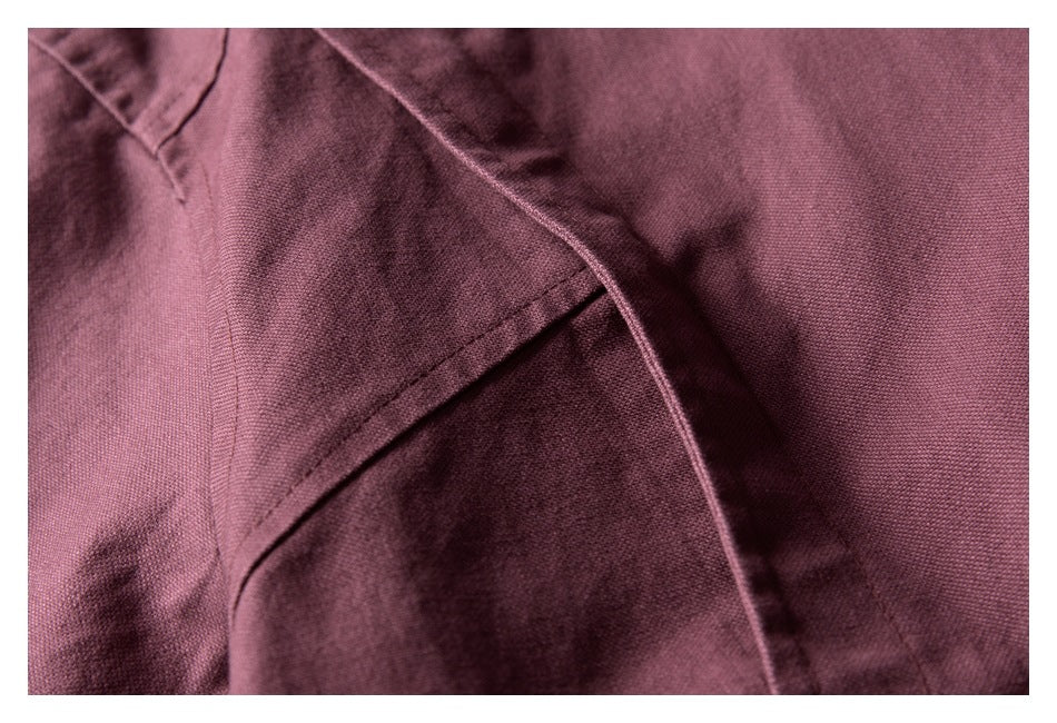 Close-up of mauve jacket fabric and stitched panel seams.