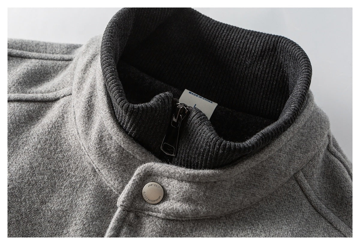 Close-up of the gray jacket's dark ribbed collar, zipper and snap-fastened collar tab.