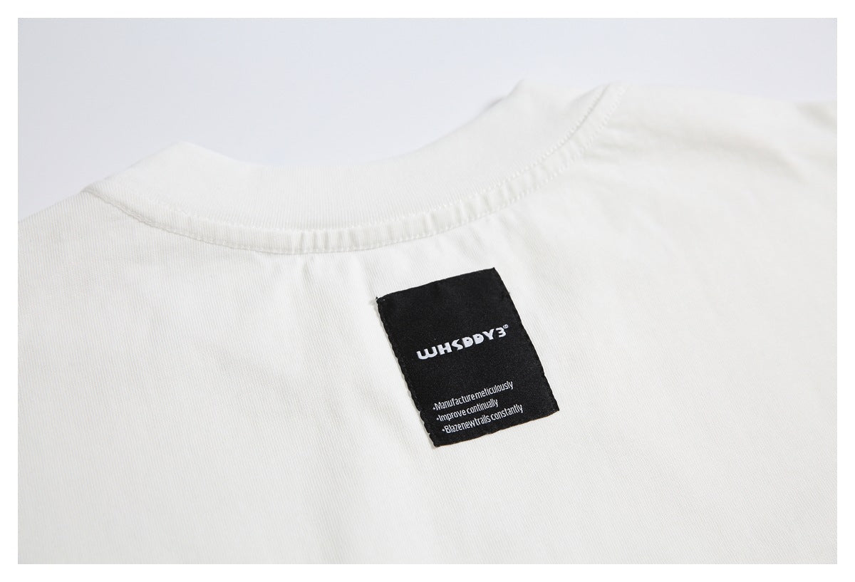 Close-up of a white shirt neckline with a black sewn label bearing stylized English lettering.