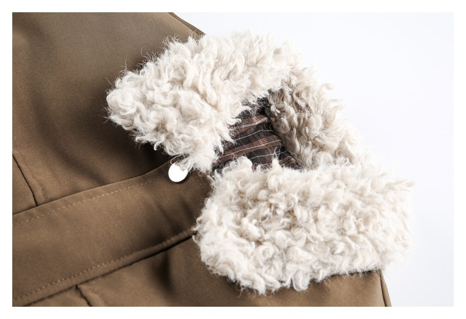 Close-up of the jacket’s cream fleece collar, plaid inner facing and snap fastening.
