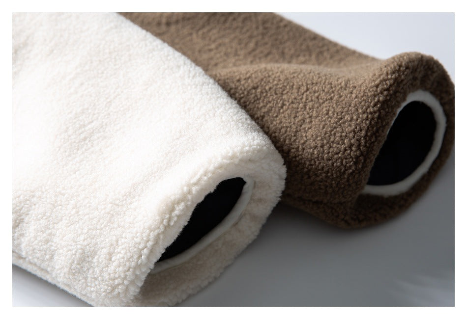 Cream and brown fuzzy garment pieces shown close up, with dark openings edged in cream.