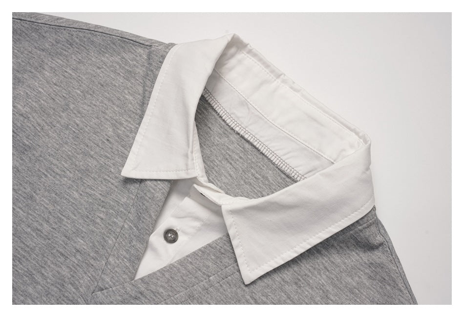 Close-up of the pullover's white pointed collar and button placket against heather gray fabric.