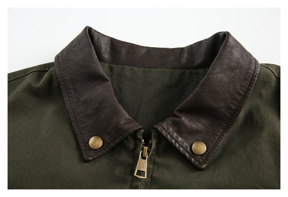 Close-up of an olive jacket's textured dark brown collar, snap buttons and front zipper.