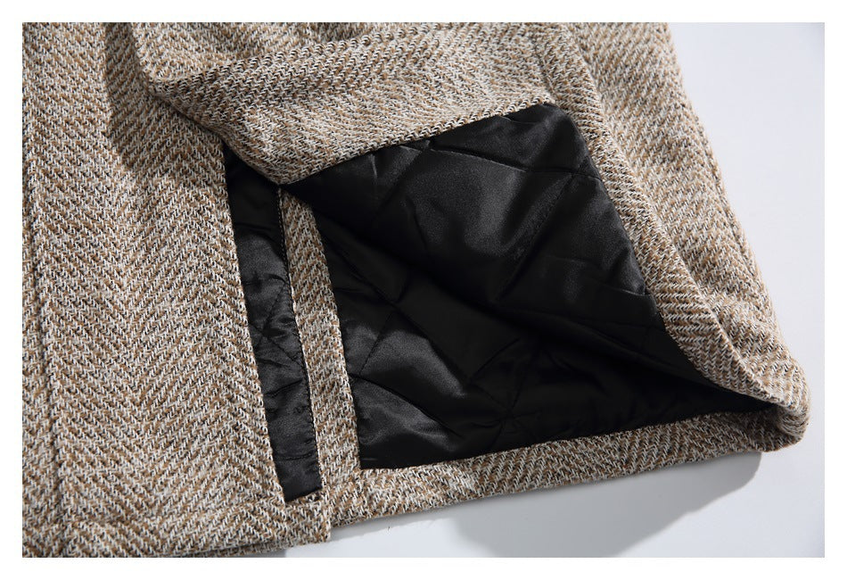 The herringbone garment is opened to show its black quilted lining and inside edge.