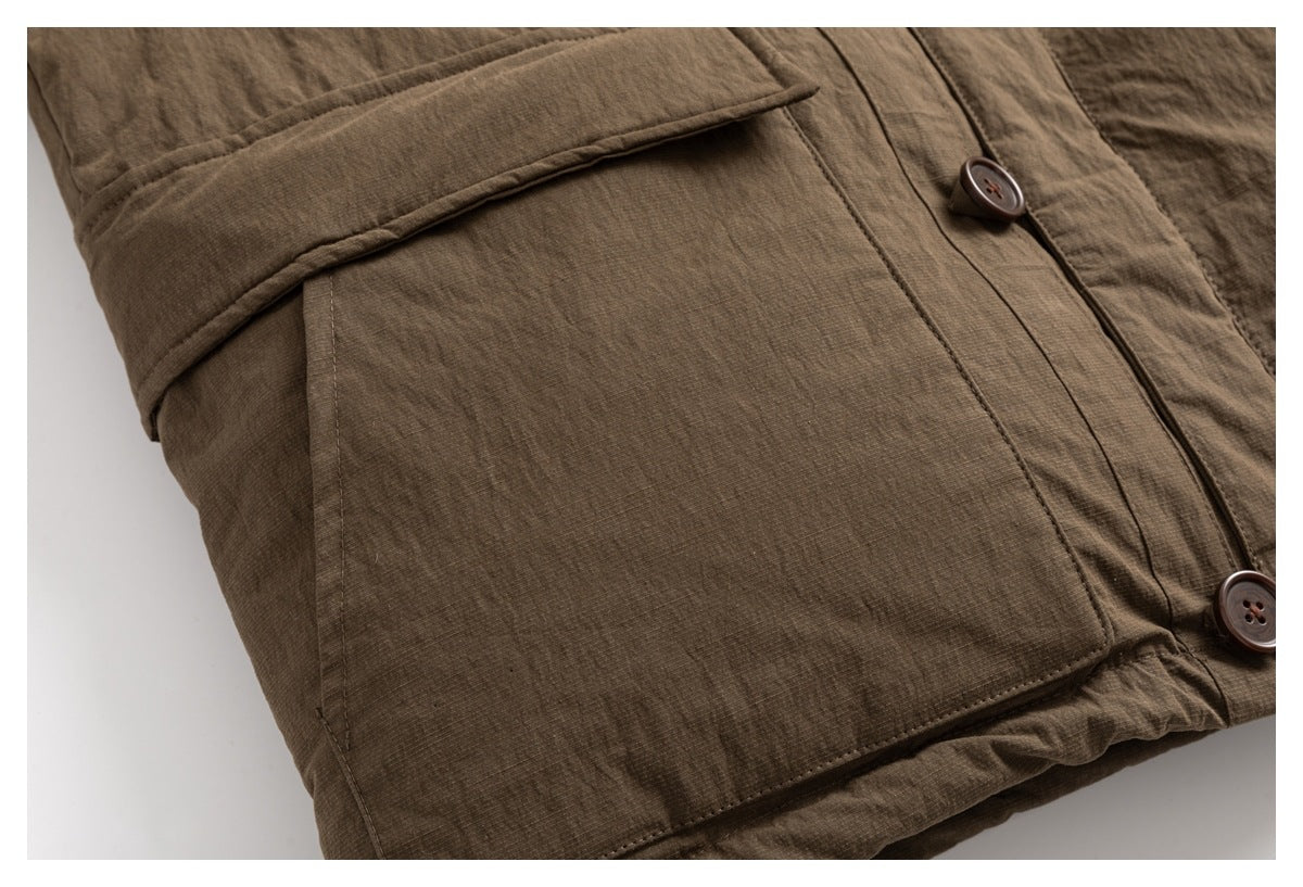 Close-up of a large flap pocket and buttons on a brown jacket.