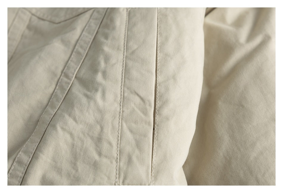 Close-up of beige garment panels and stitched seams.