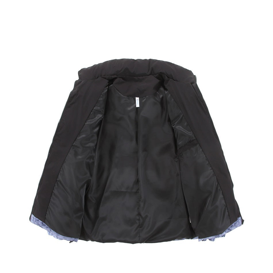 Black jacket laid open to show its shiny black lining, with a glimpse of blue-gray patterned fabric at the hem.