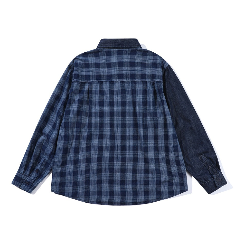 Back view of blue plaid shirt with dark denim sleeve, collar and back yoke, flat lay