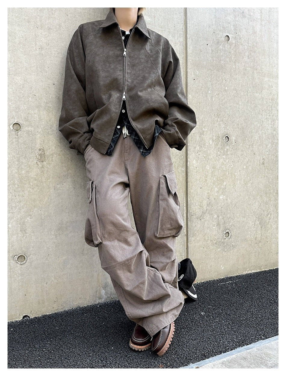 Front view of a model wearing a dark brown zip jacket and loose taupe cargo trousers.