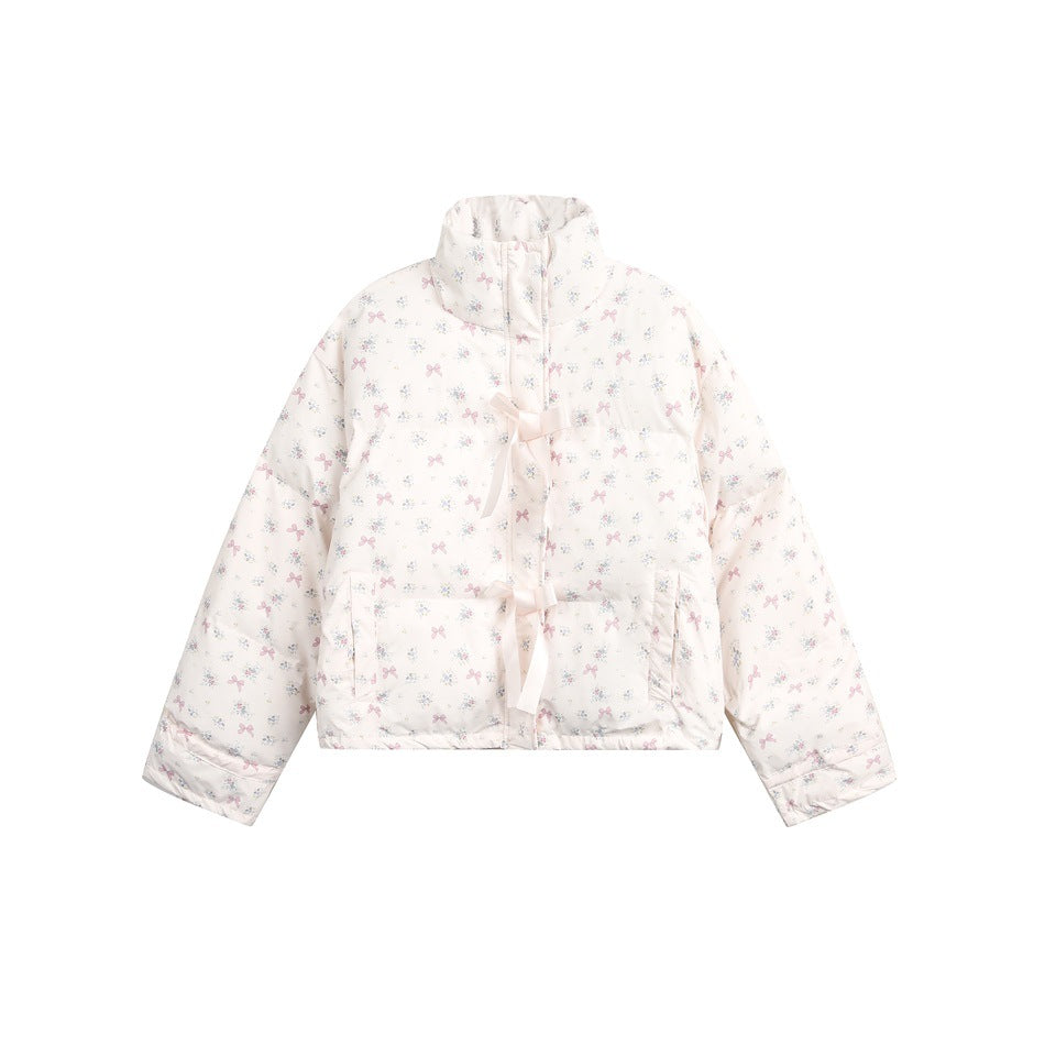 Pale pink quilted stand-collar jacket with a pink bow and floral print and two ribbon bow ties at the front