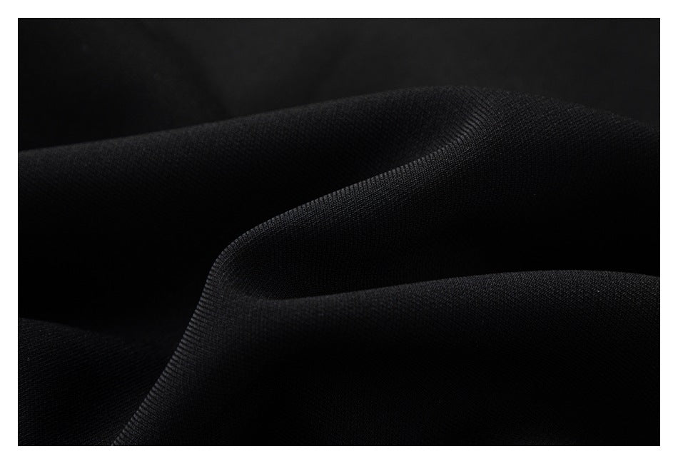 Close-up of folded black fabric showing its surface texture.