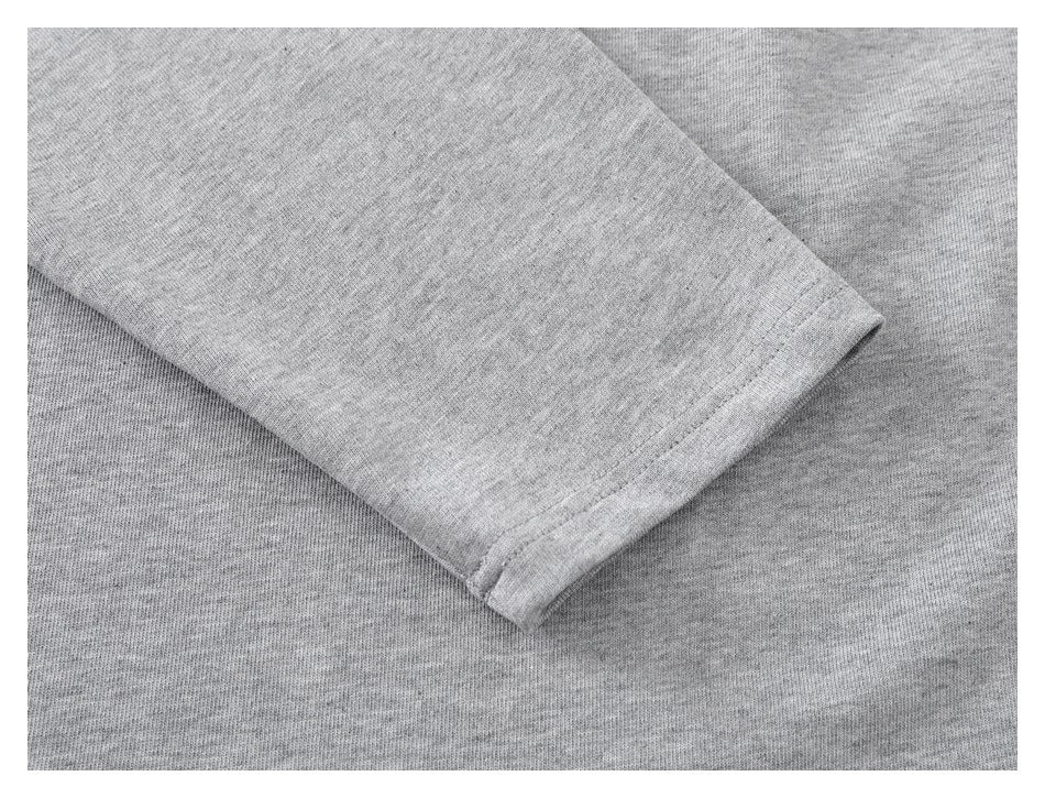 Close-up of a heather-gray sleeve cuff with visible stitching.