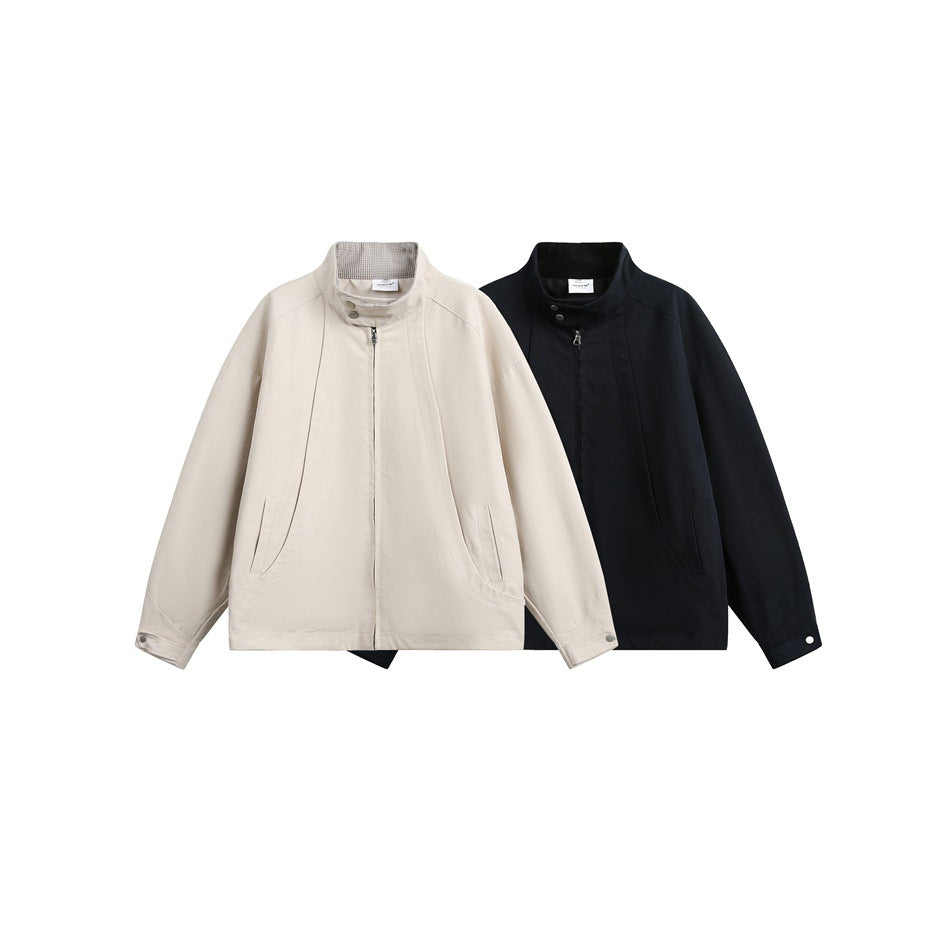 Two zip-front jackets shown together in light beige and dark navy, each with a high collar and angled pockets.