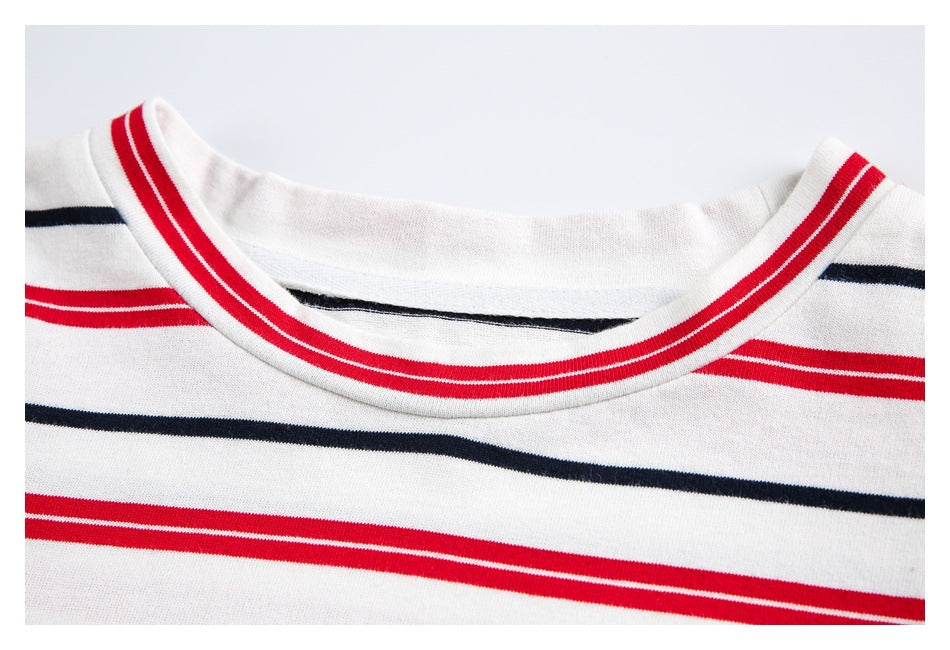 Close-up of a white shirt neckline with red and navy horizontal stripes and red-striped trim.