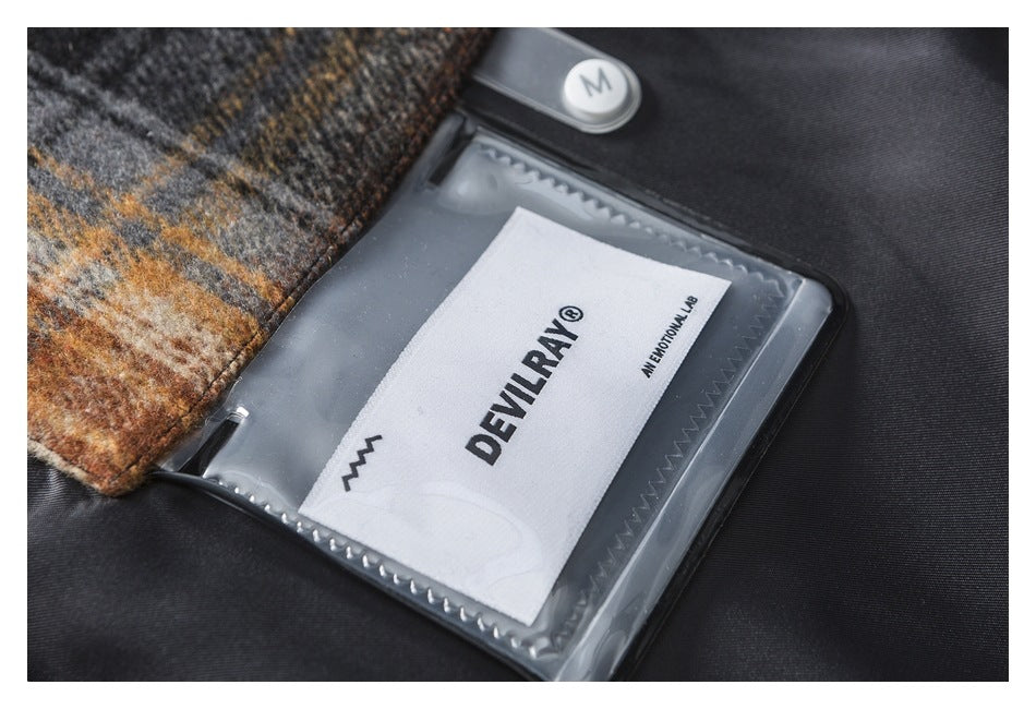 Close-up of a garment label marked DEVI... and AN EMOTIONAL LAB inside a clear pocket.