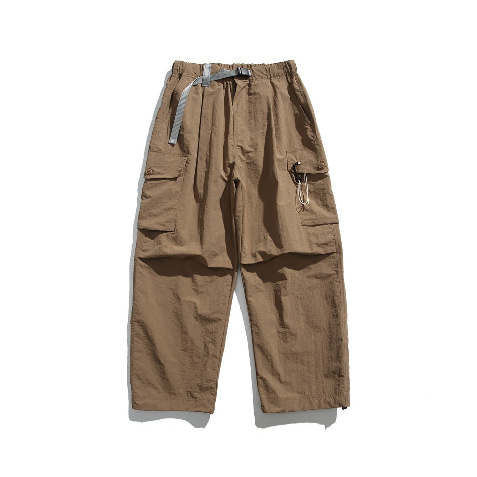Khaki wide-leg cargo pants with gray buckle belt and flap side pockets, flat lay front view