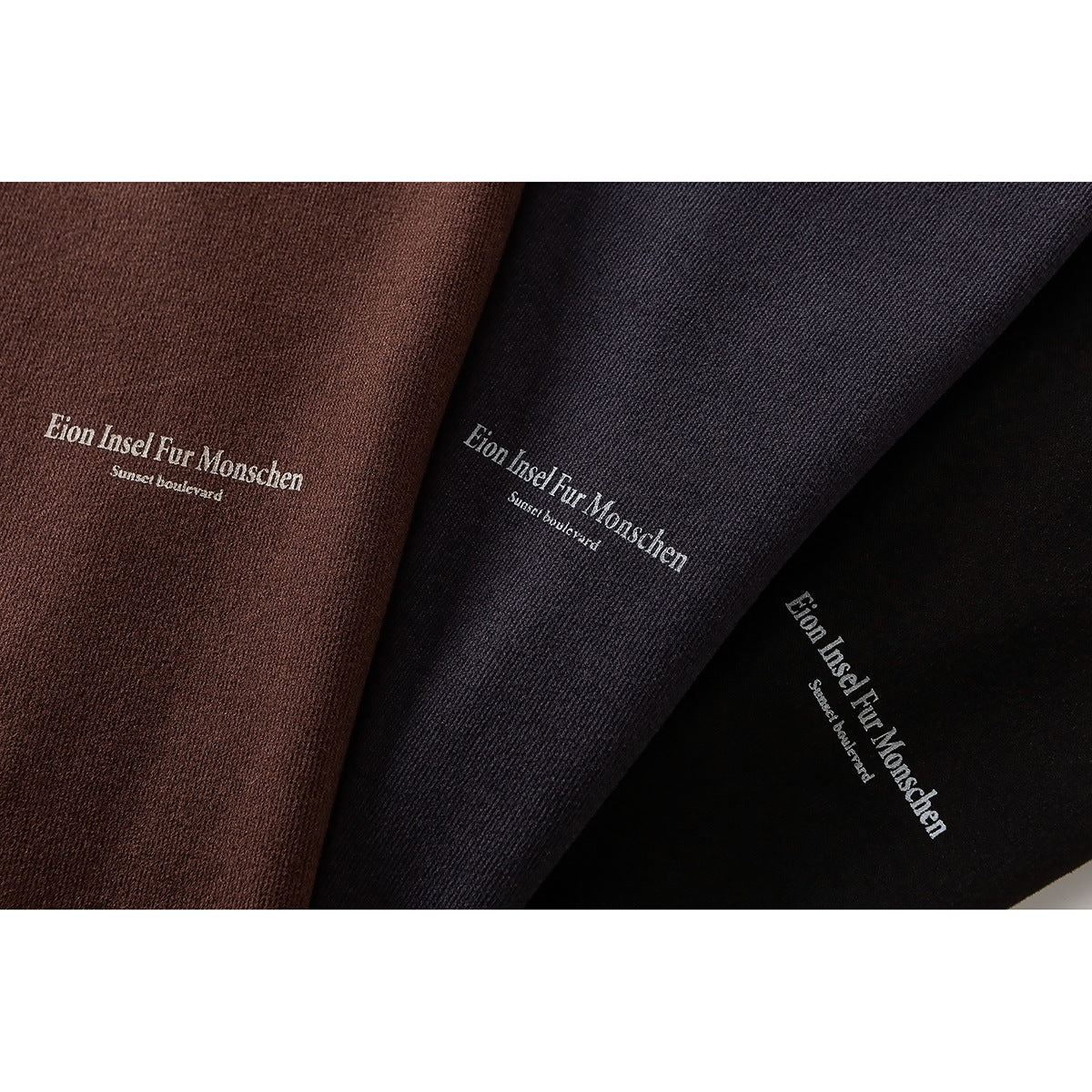 Close-up of brown, charcoal, and black fabric colorways with matching white English garment text.