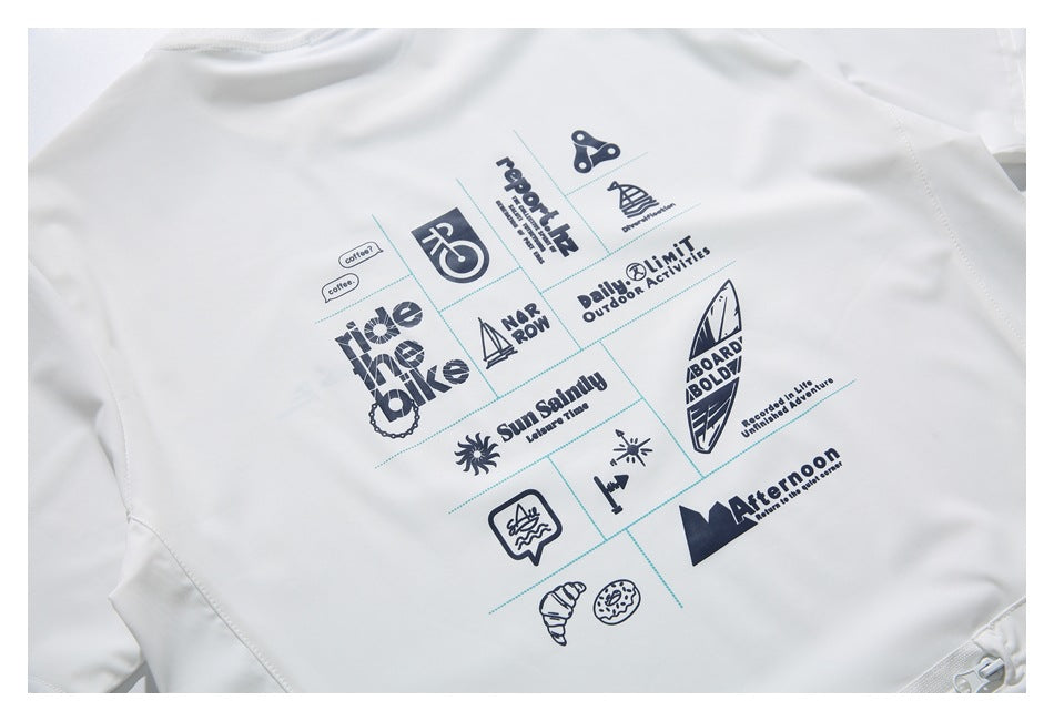 Close-up of a white garment with a navy grid of outdoor-themed icons and English words printed on it.