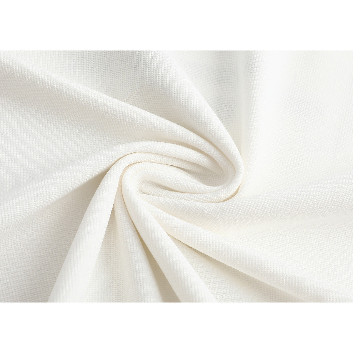Close-up of off-white fabric gathered into folds, showing its fine textured weave.