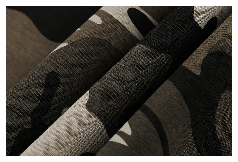 Close-up of folded fabric with a black, brown, and beige camouflage print.