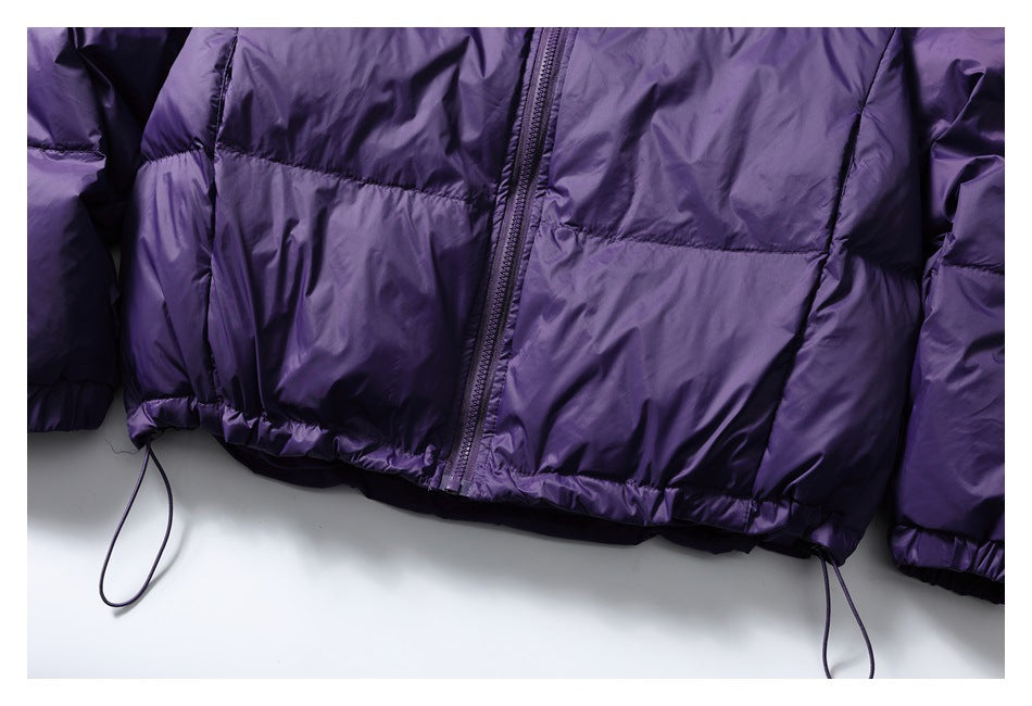 Close-up of a purple jacket’s front zipper, quilted panels, gathered hem, and adjustable drawcords.
