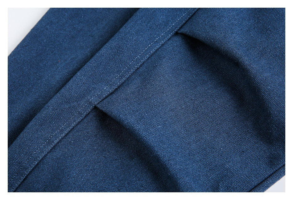 Close-up of dark blue fabric panels and a diagonal stitched seam.