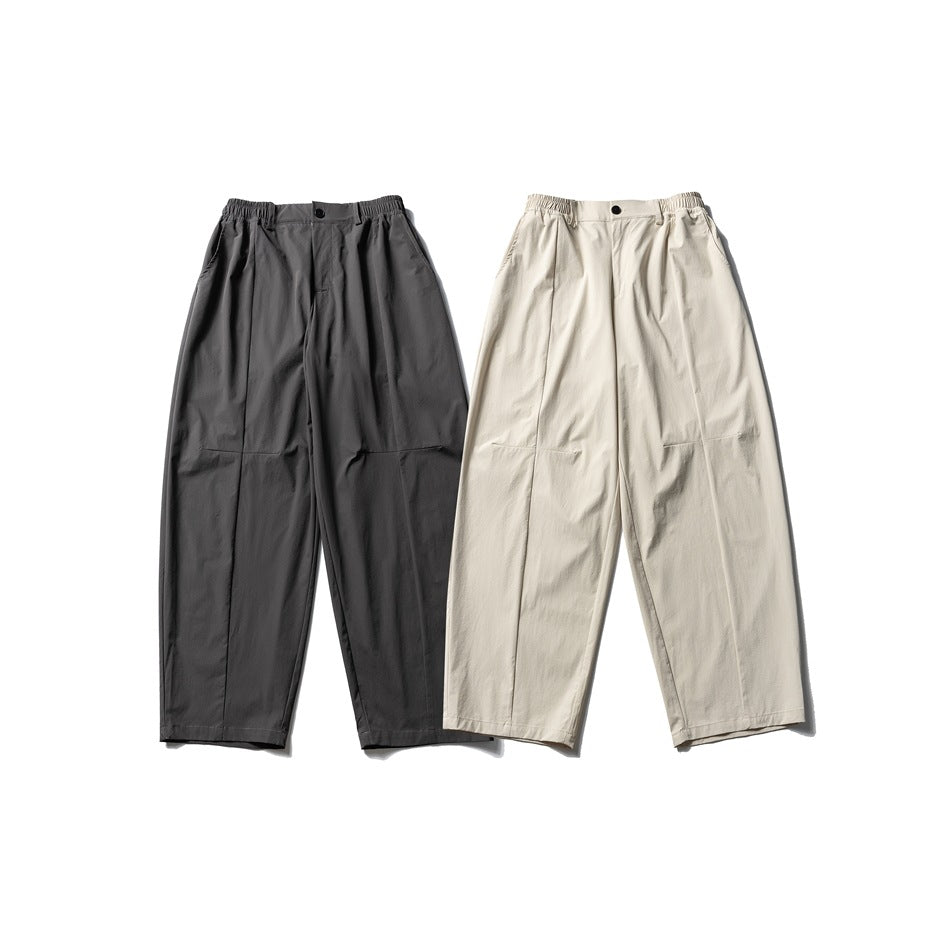 Front flat lay of wide-leg trousers in charcoal gray and cream, with elasticated waistbands and front pleats.