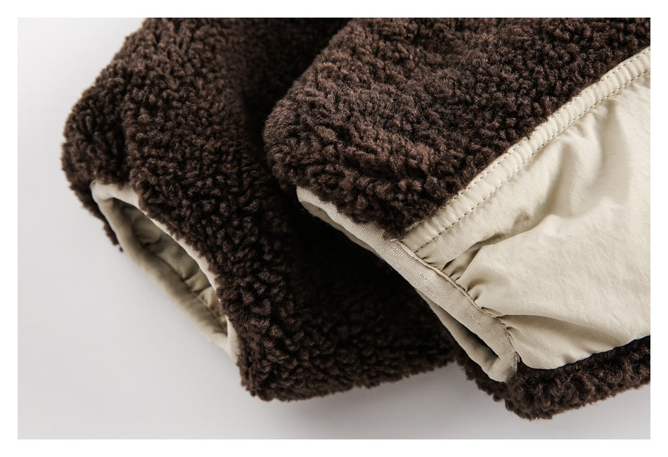 Close-up of a dark brown fleece edge and cream fabric panel with stitched trim.