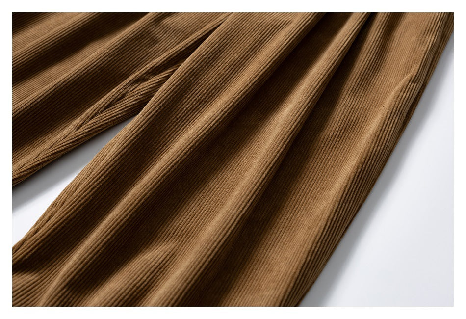 Close-up of the brown trousers' legs, showing their fine ridged corduroy texture.