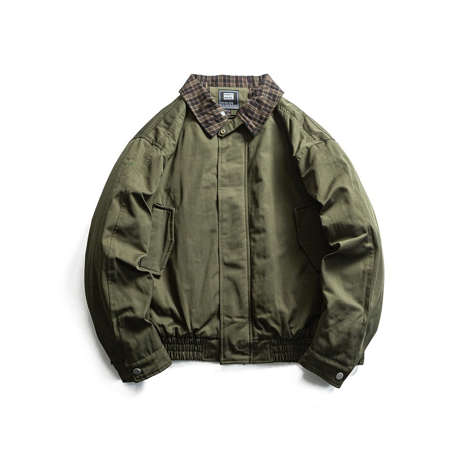 Olive green jacket with brown plaid collar, covered front placket, side pockets and ribbed hem, flat lay