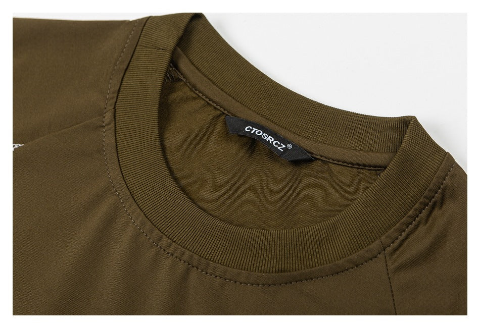 Close-up of an olive-brown T-shirt's ribbed crew neck and sewn-in black label.