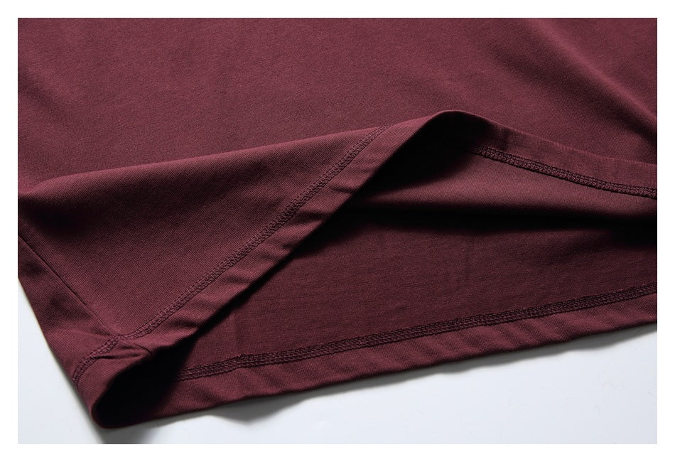 Close-up of the burgundy shirt's hem and interior seam stitching.