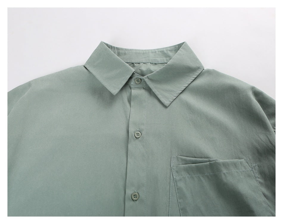 Close-up of the sage-green shirt's pointed collar, front buttons, and chest pocket.