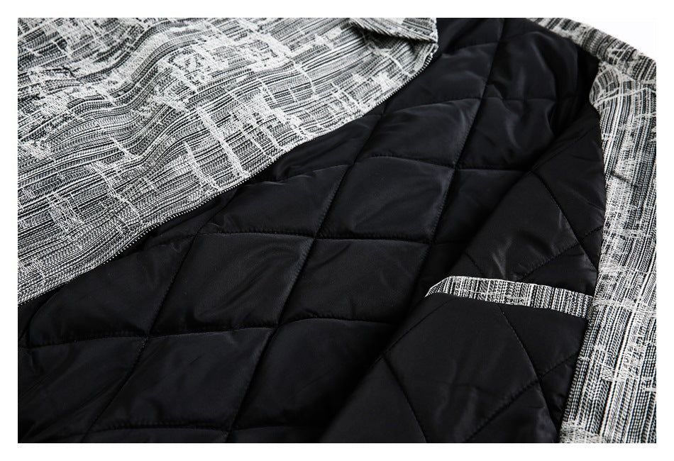 Inside view of a garment showing black diamond-quilted lining and patterned outer fabric.