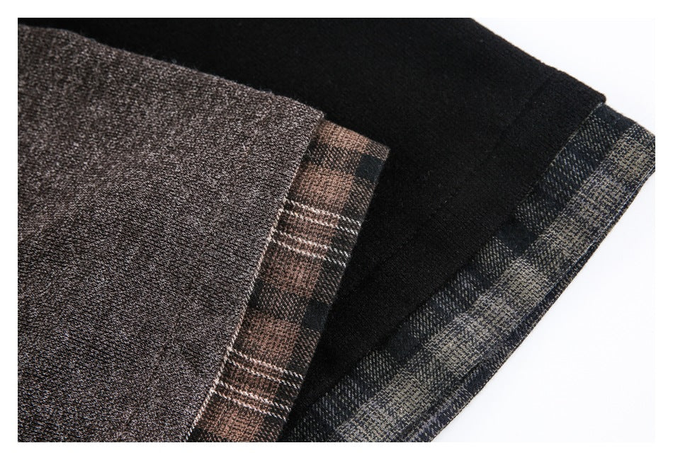 Close-up of brown and black shirt hems with contrasting plaid trim.