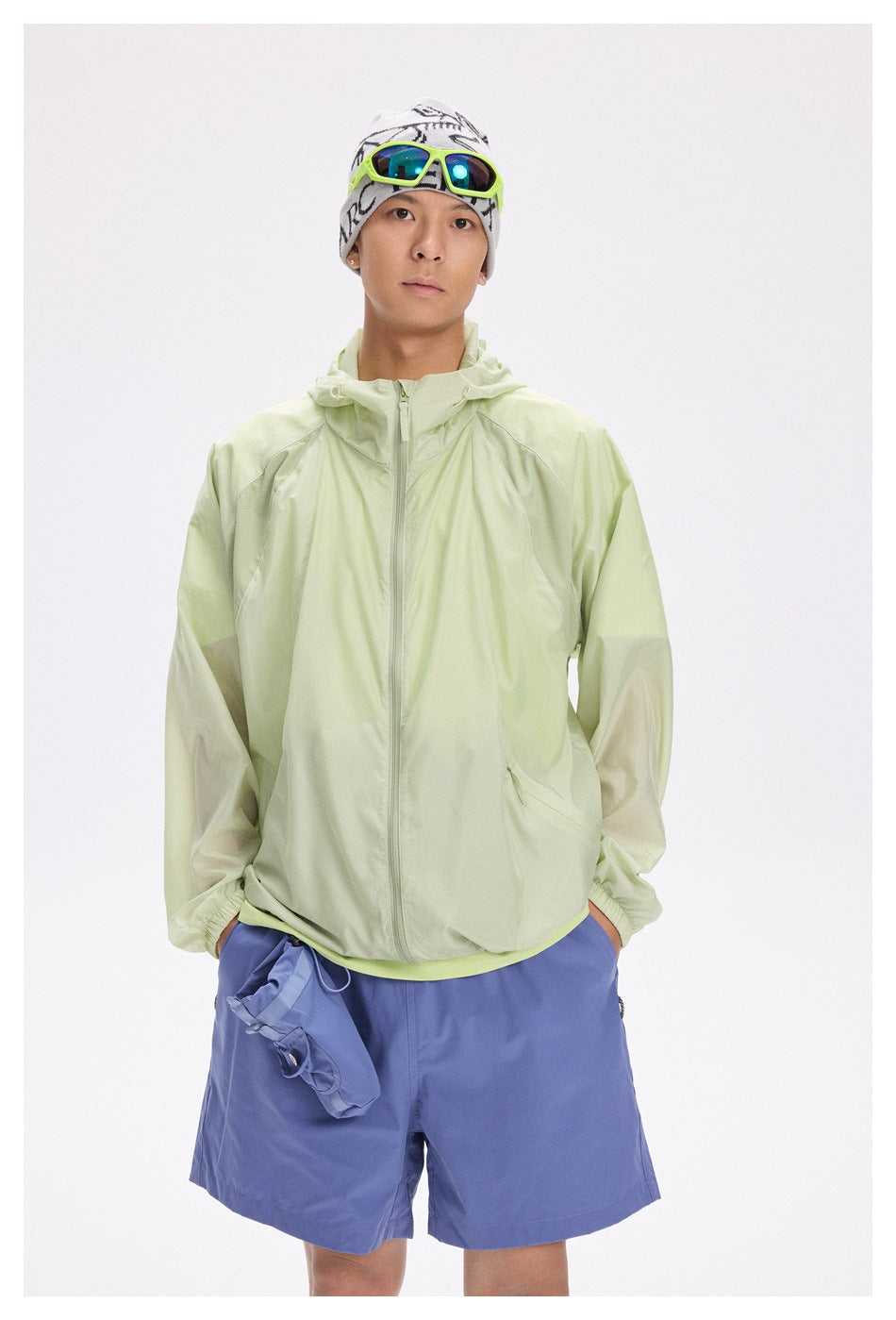 Man modeling a pale lime hooded zip jacket with mesh shoulder panels and elastic cuffs.