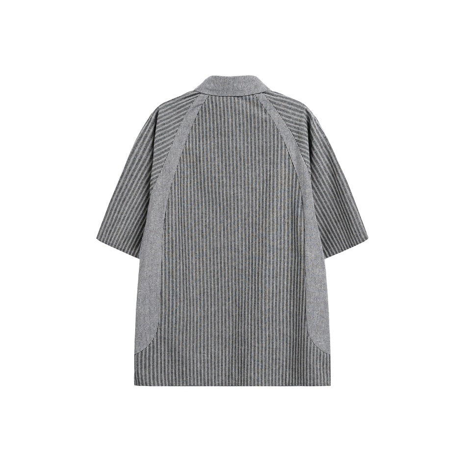 Back view of a gray striped short-sleeve shirt with contrast panels and curved side pockets, shown flat on white.