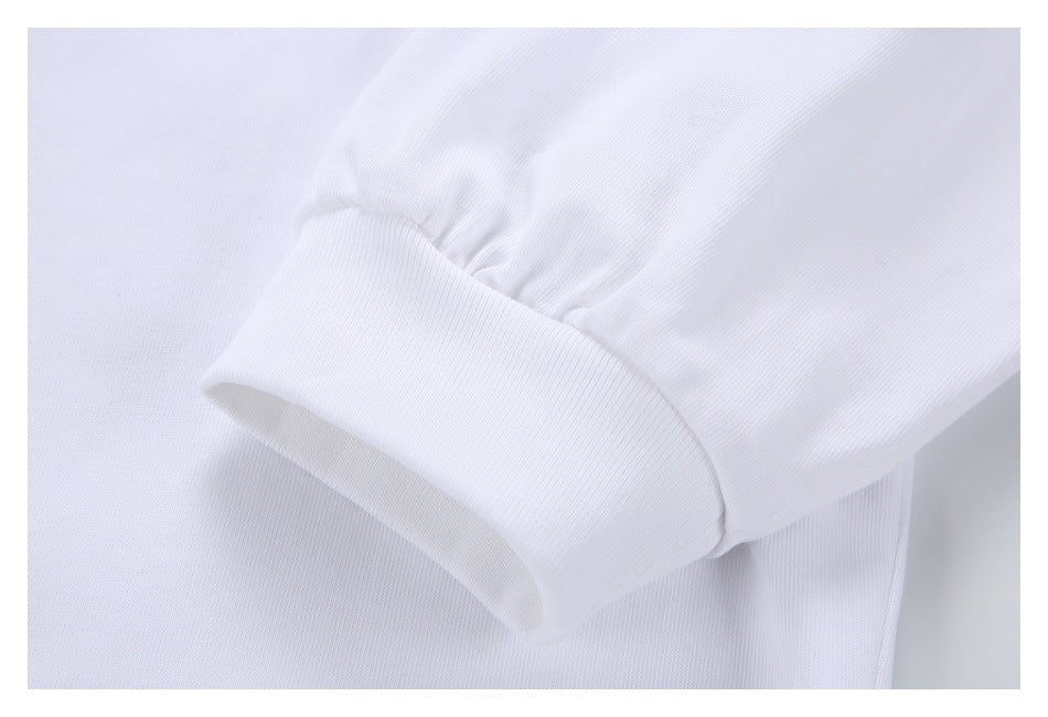 Close-up of a white sleeve gathered above a wide ribbed cuff.